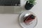 Top view of a delicious cake next to a sleek laptop computer on a white background