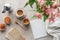 top view of delicious coffee with muffins blank paper and alstroemeria bouquet