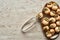 Top view of delicious cooked escargots on plate with tweezers on stone background.