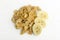 Top view of delicious corn flakes and pieces of banana on the white surface