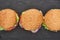 Top view of delicious fresh cheeseburgers on black table