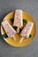 top view of delicious fruity popsicles with green mint leaves on yellow plate