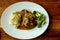 Top view of delicious grilled pork chops with mash potato and steamed green broccoli on brown wood table