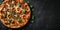 Top view delicious italian pizza on dark background.