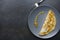 Top view of delicious omelette on grey plate, empty space