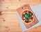 Top view of a delicious pizza with many meat, tomatoes and arugula on wooden background