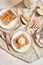 Top view of delicious plum cakes with crumbles and ice cream on plates on a white table