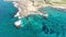 Top view of deserted sea spit with transparent ocean waters around. Aerial view of blue clear Mediterranean Sea waves