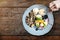 Top view of Dessert Plate on Wooden Table with Ice cream, chocolate, waffle and variety of fruit
