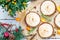 Top View of Dessert Tartlets with Berries, Meringue and Kumquat Jam on White Wooden Background