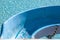 Top view of detail pf blue color a waterslide to landing in a refreshing pool in the waterpark