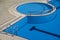 Top view detail of pool with blue water and entrance with chrome grab bars