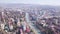 Top view of developed city on the background of mountainous landscape. Clip. Beautiful panorama of large city in valley