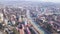 Top view of developed city on the background of mountainous landscape. Clip. Beautiful panorama of large city in valley
