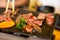 Top view of dice beef on the hot pan with chopsticks