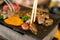 Top view of dice beef on the hot pan with chopsticks