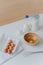 Top view of different dough recipe ingredients at kitchen table. Eggs, whisk, glass of milk and flour. Cooking, baking and