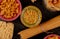 top view of different types of macaroni as bucatini cavatappi spaghetti vermicelli tagliatelle and others on wooden background