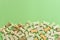 Top view of dog treats over green wooden background