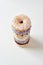 Top view of donut tower, pile of various sweet colorful donuts with sprinkles and glaze isolated over light background