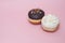 Top view Doughnuts with Chocolate and White Icing on Pastel Pink Background. Sweet Dessert Donuts with Copy Paste.