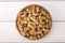 Top view of dried white mulberries fruits in a wooden bowl