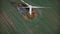 Top view drone slowly flying above working windmill turbine with red marks, alternative eco-friendly energy sources.