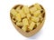 Top view dry pasta penne Italian food in heart shaped bamboo basket isolated white background with clipping path