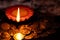 Top View of an earthen lamp glowing in the dark with money in the foreground for prosperity in Lakshmi pooja during Diwali