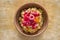 Top view on a earthenware bowl with bulgur porridge cooked in milk with sultana, pieces of pumpkin