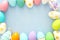 Top view of easter colorful eggs over blue background.