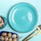 Top view Easter table setting fragment - empty blue plate, golden cutlery, quail eggs on blue.