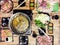 Top view eating.Sukiyaki and shabu soup with fish, white vegetable on wooden