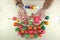 Top view of eggs are painted against paintbrush by hands of christian for easter day on marble top background.