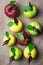 Top view of eight colorful apples with water drops and leaves on