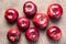 Top view of eight colorful bright shiny red apples on brown sack