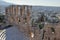 Top view of the elements of the Odeon of Herodes Atticus. View of the city through the arches of the  ruins of the Acropol