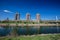 Top view of the embankment of the Neckar River. Bridge, green grass and trees. Different high-rise buildings. Mannheim.