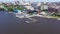 Top view of embankment with sailing yachts on background of city. Video. Beautiful panorama of large city near coast