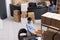Top view of employee standing at desk in warehouse while preparing client order putting clothes in carton box