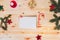 Top view empty paper letter wishlist for Santa Claus with envelope, candy shape pencil, gift box and Christmas decor on