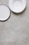top view of empty plates on concrete tabletop