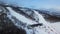 Top view of empty ski slope in winter. Stock footage. Beautiful deserted ski track near forest on winter evening day