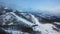 Top view of empty ski slope in winter. Stock footage. Beautiful deserted ski track near forest on winter evening day