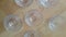 Top view of empty white glass bowls on a wooden floor