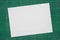 Top view of empty white paper A4 size on old grunge green dirty cutting mat, copy space for text and graphic