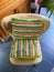 Top view on empty wing back chair with colorful cushions from seventies in german living room