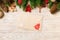Top view of envelope, Christmas toys, decorations and fir tree branches on wooden background. New Year holiday concept