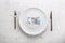 Top of view euro banknotes on white plate with fork and knife