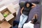 Top view excited African American couple taking break, unpack boxes